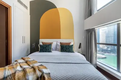 a bedroom with a bed and a window at The Smart Concierge - Bay Central in Dubai