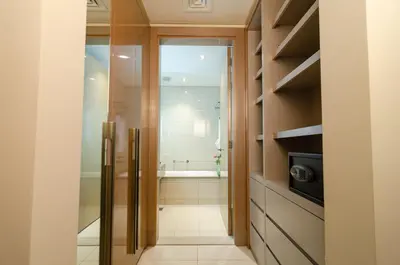 a bathroom with a walk in shower and a tub at Royal Club By RVHR, Paramount Tower B, Business Bay in Dubai