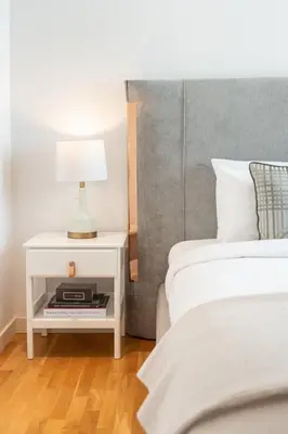 a bedroom with two beds and a table with a lamp at GuestReady - The Best Bluewaters View in Dubai