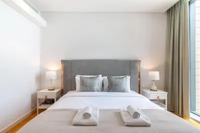 a bedroom with a large bed with two towels on it at GuestReady - The Best Bluewaters View in Dubai