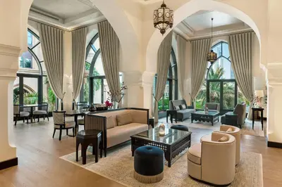 a living room with a couch and a table at Palace Downtown in Dubai