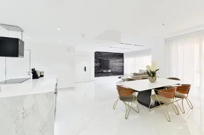 a kitchen and dining room with a table and chairs at Waterfront Luxury 3BR with maids room in JBR, Dubai in Dubai