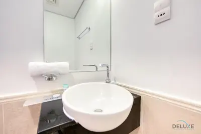 a bathroom with a white sink and a mirror at Homely 1BR at The Matrix Dubai Sports City by Deluxe Holiday Homes in Dubai