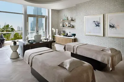 a bedroom with two beds and a large window at Address Downtown in Dubai