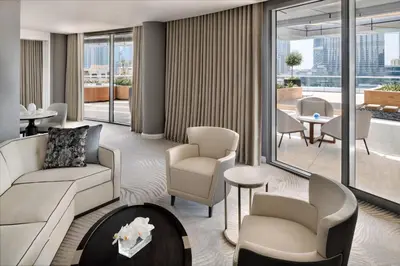 a living room with a couch and chairs and windows at Address Downtown in Dubai
