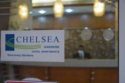 a sign that reads chilea gardensmedicalaris hospitalagents at Chelsea Gardens Hotel Apartment in Dubai