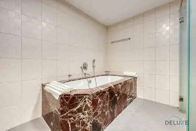 a bathroom with a tub with a marble counter top at Outstanding 3BR at Sadaf 7 JBR by Deluxe Holiday Homes in Dubai