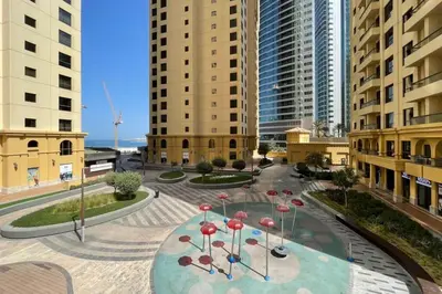 a courtyard in a city with tall buildings at The Smart Concierge - Bahar 6 in Dubai