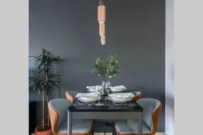 a dining room table with chairs and a table with plates at The Smart Concierge - Bahar 6 in Dubai