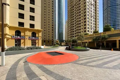 a red circle in a courtyard in a city at The Smart Concierge - Bahar 6 in Dubai