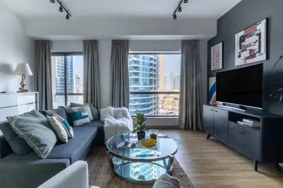 a living room with a couch and a glass table at The Smart Concierge - Bahar 6 in Dubai