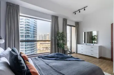 a bedroom with a large window with a view of a city at The Smart Concierge - Bahar 6 in Dubai