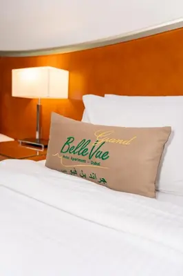a bed with a pillow sitting on top of it at Belle Vue Building in Dubai
