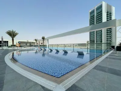 a swimming pool on the roof of a building at GuestReady Holiday Homes - A Rose in the Sky in Dubai