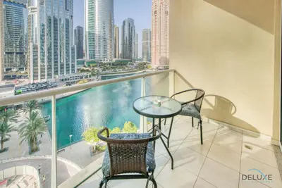 a balcony with a table and chairs and a view of the city at Calm Studio at Lake View Tower JLT by Deluxe Holiday Homes in Dubai