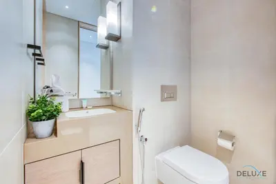 a white bathroom with a toilet and a sink at Classy 1BR at The Address Residences in JBR by Deluxe Holiday Homes in Dubai