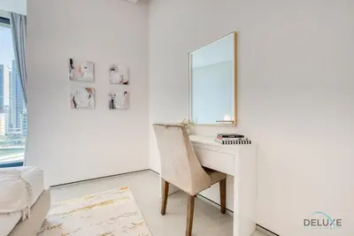 a desk with a mirror and a chair in a room at Classy 1BR at The Address Residences in JBR by Deluxe Holiday Homes in Dubai