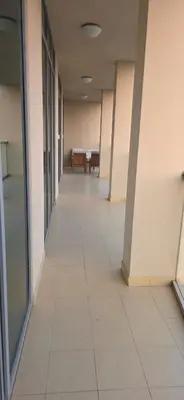 an empty hallway of an office building with a table at Cozy 2 BR apt Golf Tower Greens, stunning Golf views in Dubai