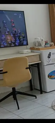 a desk with a computer and a chair next to a washing machine at Jumeirah Beach Villa in Dubai