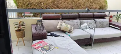 a couch sitting on a balcony with pillows on it at Jumeirah Beach Villa in Dubai