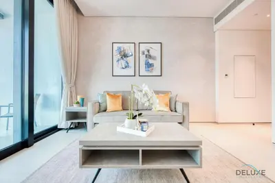 a living room with a couch and a table at Posh 1BR at The Address Residences in JBR by Deluxe Holiday Homes in Dubai