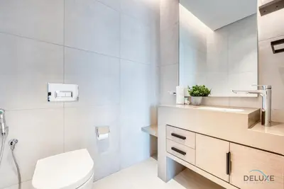 a bathroom with a toilet and a sink at Posh 1BR at The Address Residences in JBR by Deluxe Holiday Homes in Dubai