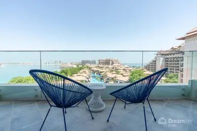 two chairs on a balcony with a view of the ocean at Dream Inn Apartments - Mina by Azizi in Dubai