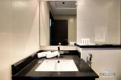 a bathroom with a sink and a mirror at Sea Views 1BR in the Heart of Dubai Marina by Deluxe Holiday Homes in Dubai