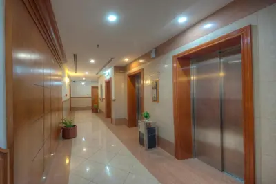 a hallway of an office building with a elevator at La Villa Najd Hotel Apartments in Dubai