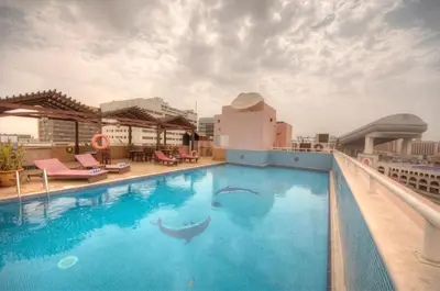 a swimming pool on the roof of a building at La Villa Najd Hotel Apartments in Dubai