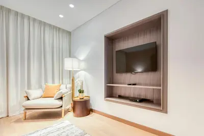 a living room with a tv and a chair at Palm Jumeirah Luxury Apartments by Propr in Dubai