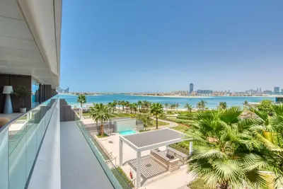 a view of the beach from the balcony of a building at Palm Jumeirah Luxury Apartments by Propr in Dubai