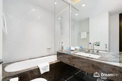 a bathroom with a tub and a sink at Dream Inn - Damac Heights by Fendi in Dubai