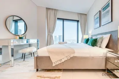 a bedroom with a bed and a desk and a mirror at Captivating 1BR at The Address Residences in JBR by Deluxe Holiday Homes in Dubai