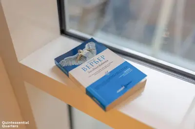 a book sitting on a table next to a window at Peaceful Oasis 3BR+kids, 7 min walk to Dubai Mall in Dubai