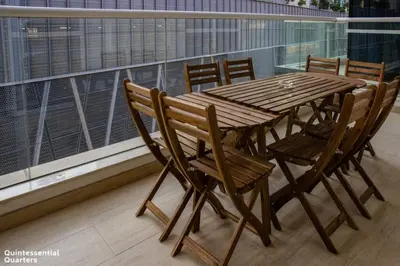 a wooden table and chairs on a balcony at Peaceful Oasis 3BR+kids, 7 min walk to Dubai Mall in Dubai
