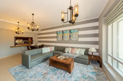 a living room with a couch and a table at One Bedroom in Burj Views by Radiance Vacation Stays in Dubai