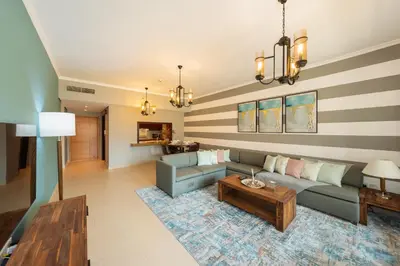 a living room with a couch and a table at One Bedroom in Burj Views by Radiance Vacation Stays in Dubai