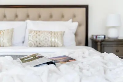 a bed with a book and a magazine on it at The Smart Concierge - 8 BLVD Walk in Dubai