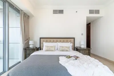 a bedroom with a large bed with two night stands at The Smart Concierge - 8 BLVD Walk in Dubai