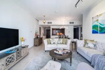 a living room with couches and a flat screen tv at The Smart Concierge - 8 BLVD Walk in Dubai