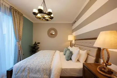 a bedroom with a bed and a chandelier at Burj Residence by Radiance Vacation Stays in Dubai
