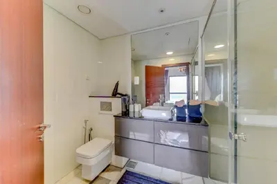 a bathroom with a toilet and a sink and a shower at VIP Castles JBR Rimal 3 Suite 1 Bedroom in Dubai