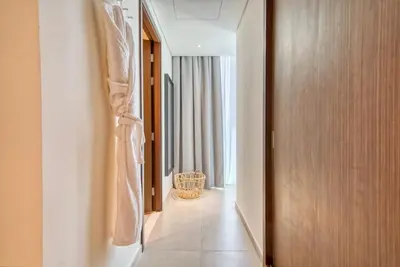 a hallway of a hotel room with a door at Incredible Views From This Classy Apt With Terrace in Dubai