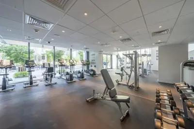 a gym with treadmills and exercise equipment in a building at Incredible Views From This Classy Apt With Terrace in Dubai