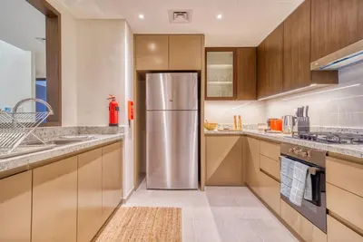 a kitchen with a stainless steel refrigerator at Incredible Views From This Classy Apt With Terrace in Dubai