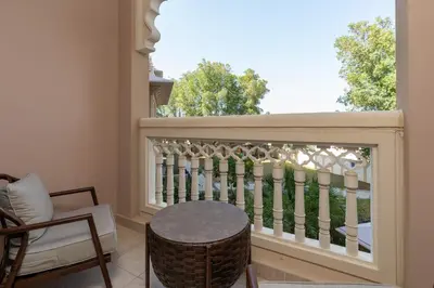 a balcony with a table and a fence at Royal Club By RVHR, Grandeur Residence Crescent Palm Jumeirah in Dubai
