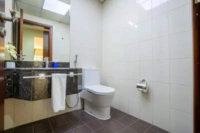 a bathroom with a toilet and a sink at RH- Prime Location, Spacious 2BR, walk to Dubai Mall in Dubai