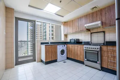 a large kitchen with a washer and dryer in it at RH- Prime Location, Spacious 2BR, walk to Dubai Mall in Dubai