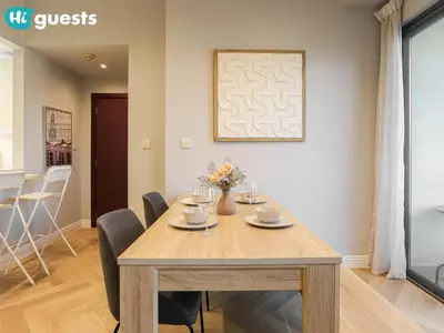 a dining room with a wooden table and chairs at HiGuests - Artistic Waterfront Apt, Perfect for Beach Lovers in Dubai